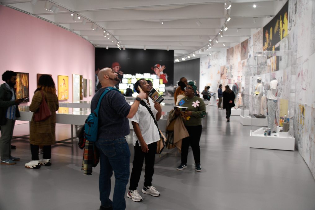 A gallery interior with a group moving through it.